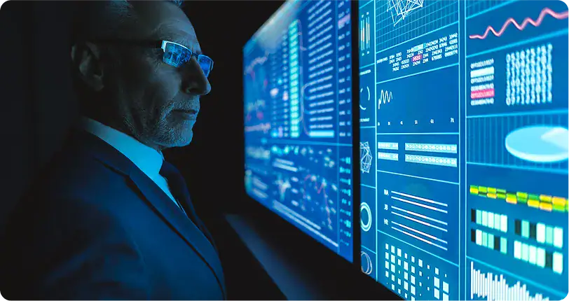 Professional man observing large digital data screens