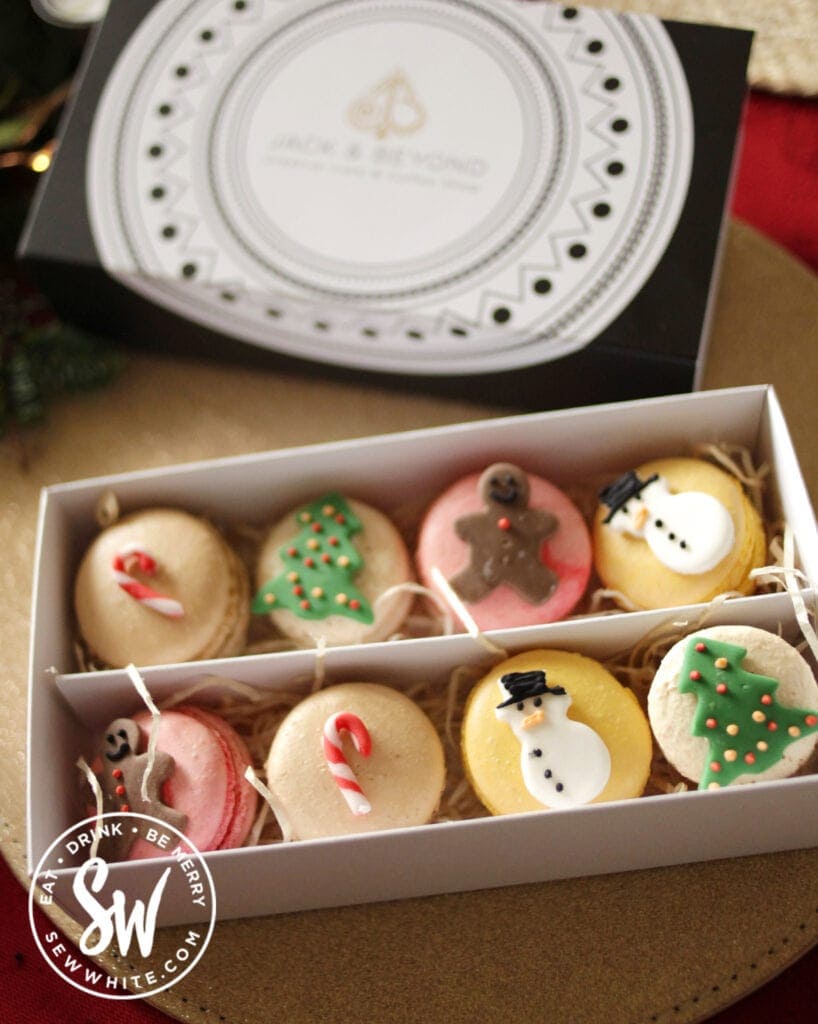 box of macarons with Christmas decorations in the food for Christmas 2021