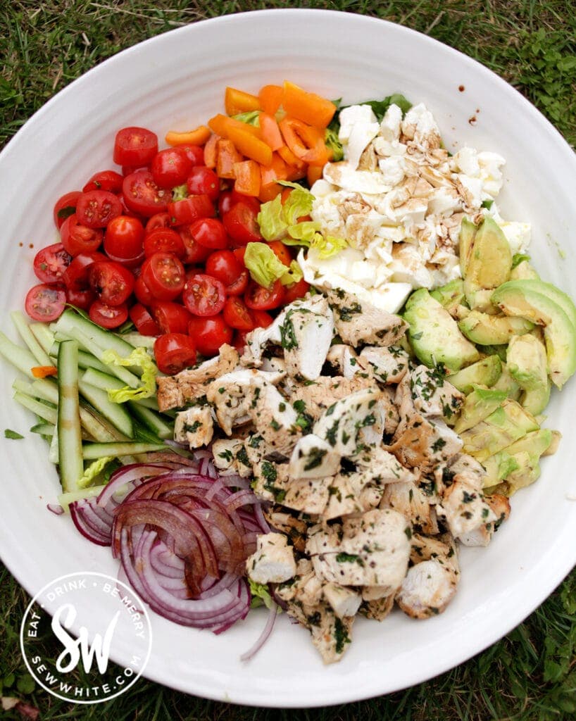 top view of the Chicken Salad Bowl with chicken, tomatoes, avocado, cucumber and red onion