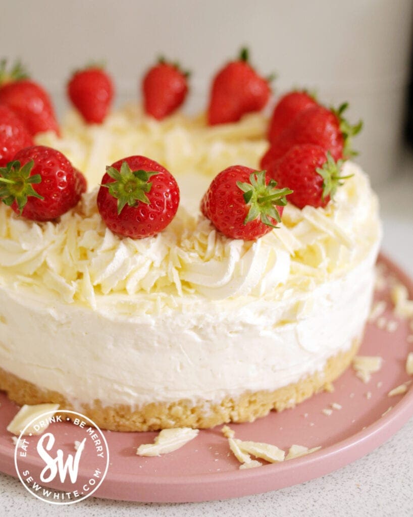 Philadelphia cheesecake topped with white chocolate and strawberries