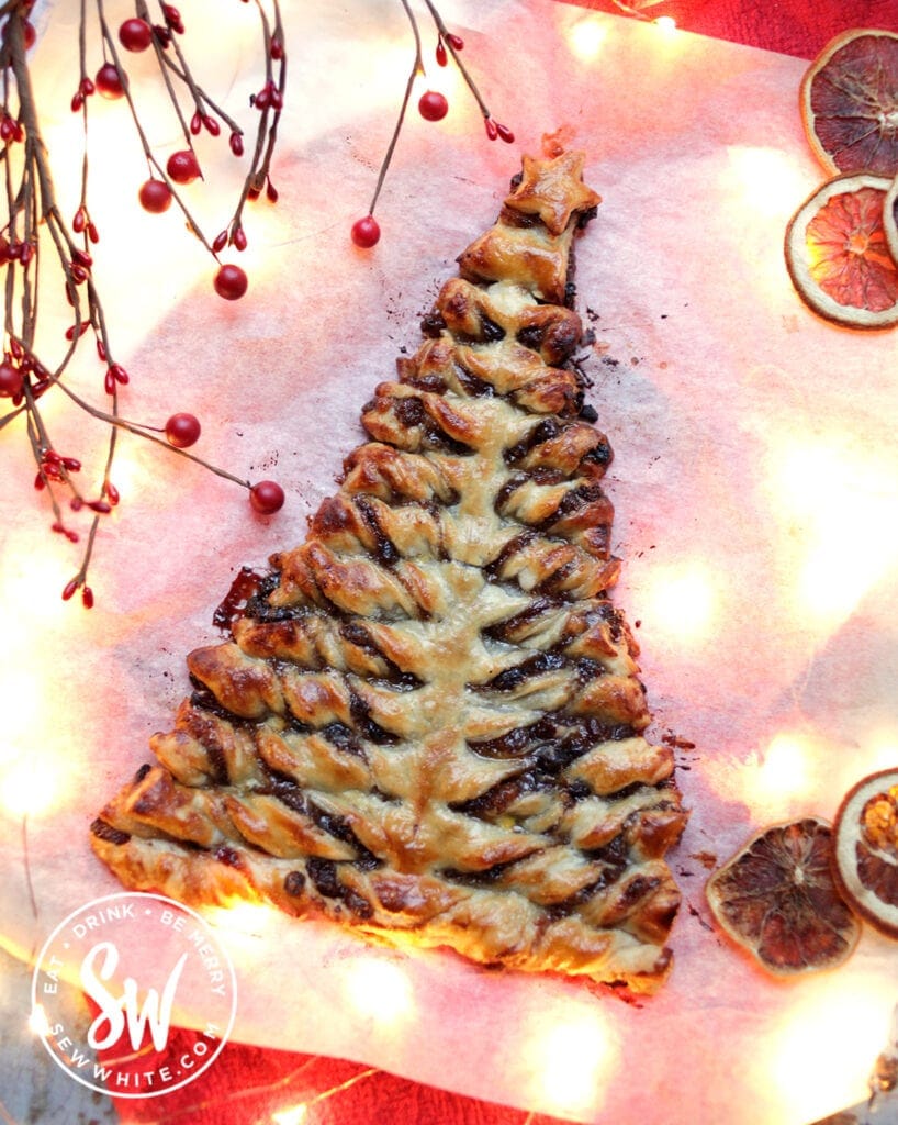 mincemeat puff pastry Christmas tree surrounded by dired oranges and red berries