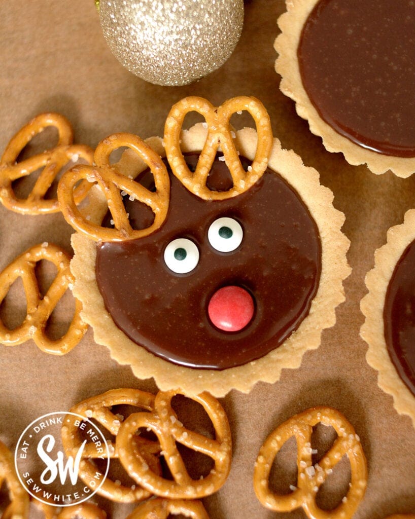 individual reindeer tart with pretzel antlers and a red button nose