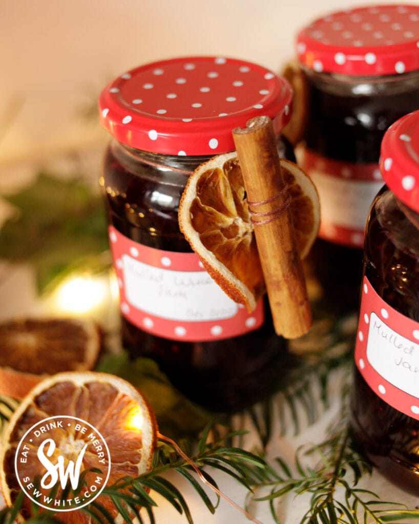 Mulled Wine Jam decorated with dried orange slices and cinnamon sticks