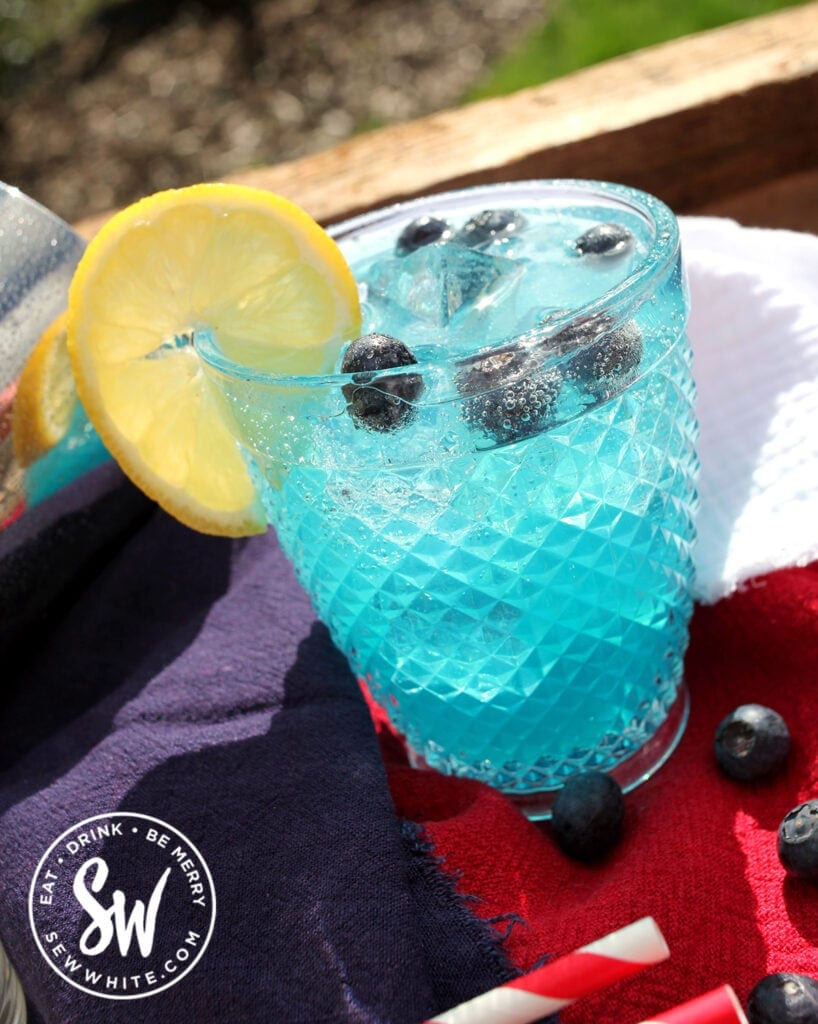 bright Blue Curacao Cocktail Recipe with a fresh elmon wheel