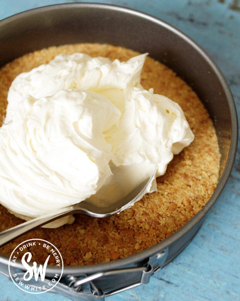 adding the cream cheese layer to the no bake cheesecake