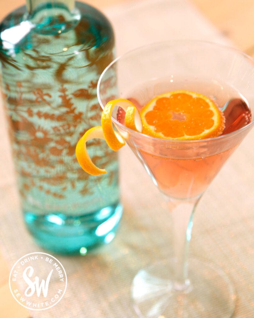 clementine cocktail in a cocktail glass with orange slice