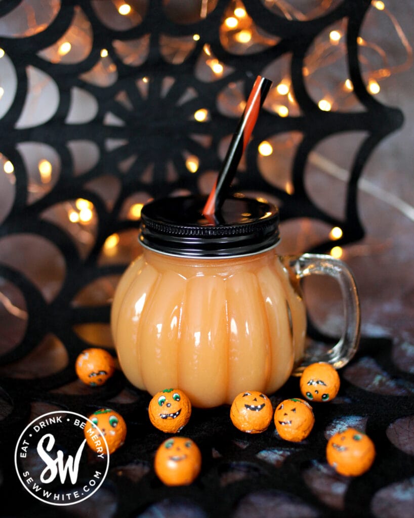 Vodka Halloween Cocktail with happy pumpkin decorations