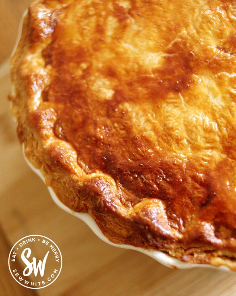 close up of golden brown puff pastry easy steak and ale pie