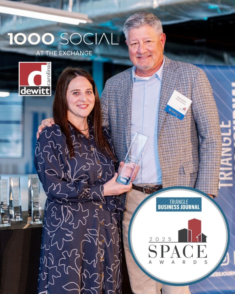 Dewitt CEO poses with the Triangle Business Journal's SPACE award, celebrating 1000 Socials state of the art Raleigh office, retail, and event space