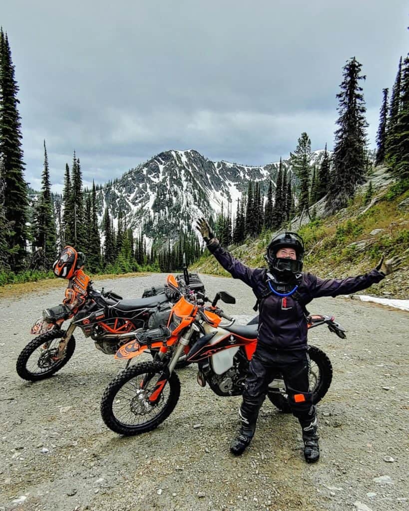 motorcycle rider and motorbikes at summit of Gray Creek Pass