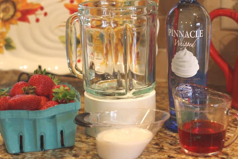 Cheers to Strawberry season. With just a few simple ingredients, you can make your own Strawberry Shortcake Daiquiris at home. Skip the mix and make fresh strawberry daiquiris at home using this easy recipe. It's the perfect slushy cocktail for cooling down in warmer weather! #strawberrydaiquiri #cocktails #slush