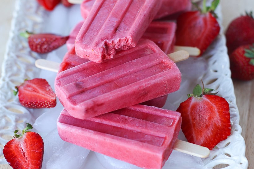 Keep cool this summer with these healthy Strawberries and Cream Popsicles.  Kids young and old will love this healthy summer snack recipe. These strawberry frozen treats won't last long. #popsicles #healthypopsicles #strawberrypopsicles #popsiclerecipe