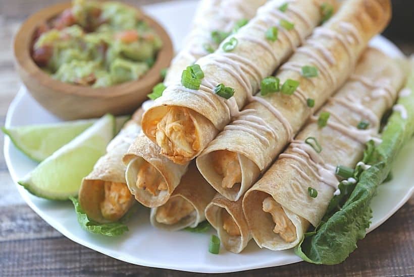 These Baked Buffalo Chicken Flautas as crispy, cheesy and full of buffalo chicken flavor. Feed a crowd this Cinco de Mayo with these delicious Baked Buffalo Chicken Flautas. If you love Mexican food, try this easy Mexican recipe. Flautas are quick and easy to prepare. Flautas are a great make-ahead freezer meal too.