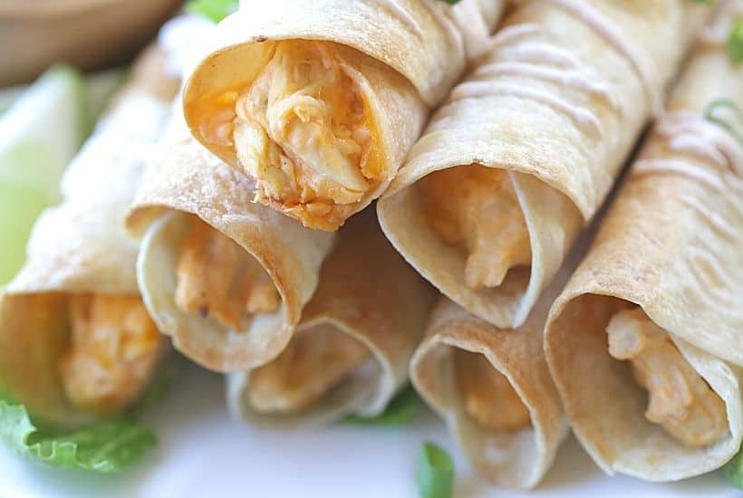 These Baked Buffalo Chicken Flautas as crispy, cheesy and full of buffalo chicken flavor. Feed a crowd this Cinco de Mayo with these delicious Baked Buffalo Chicken Flautas. If you love Mexican food, try this easy Mexican recipe. Flautas are quick and easy to prepare. Flautas are a great make-ahead freezer meal too.