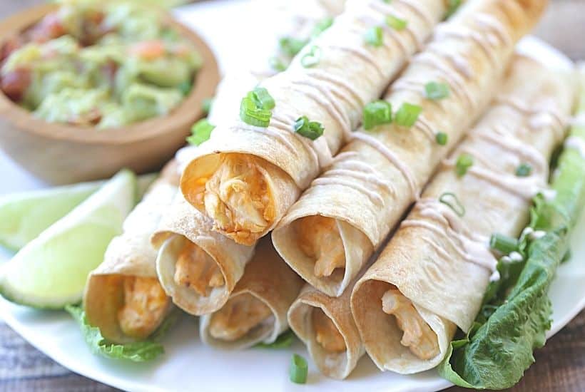 These Baked Buffalo Chicken Flautas as crispy, cheesy and full of buffalo chicken flavor. Feed a crowd this Cinco de Mayo with these delicious Baked Buffalo Chicken Flautas. If you love Mexican food, try this easy Mexican recipe. Flautas are quick and easy to prepare. Flautas are a great make-ahead freezer meal too.