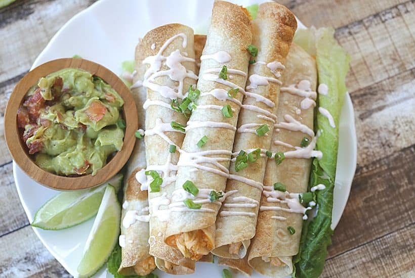 These Baked Buffalo Chicken Flautas as crispy, cheesy and full of buffalo chicken flavor. Feed a crowd this Cinco de Mayo with these delicious Baked Buffalo Chicken Flautas. If you love Mexican food, try this easy Mexican recipe. Flautas are quick and easy to prepare. Flautas are a great make-ahead freezer meal too.