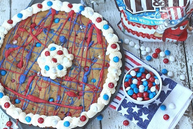 This festive Firecracker Cookie Cake recipe is the perfect dessert for your patriotic celebration! This easy chocolate chip cookie is decorated in red, white and blue and is a perfect recipe for the 4th of July, Memorial Day or Labor Day.