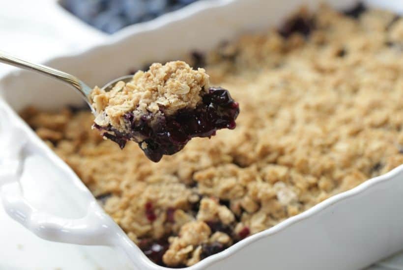 It's blueberry season! This easy blueberry crisp recipe it the perfect way to celebrate. This fruit crisp is a super simple summer dessert and perfect with a dollop of ice cream. #blueberrycrisp #blueberryrecipe #summerdessert