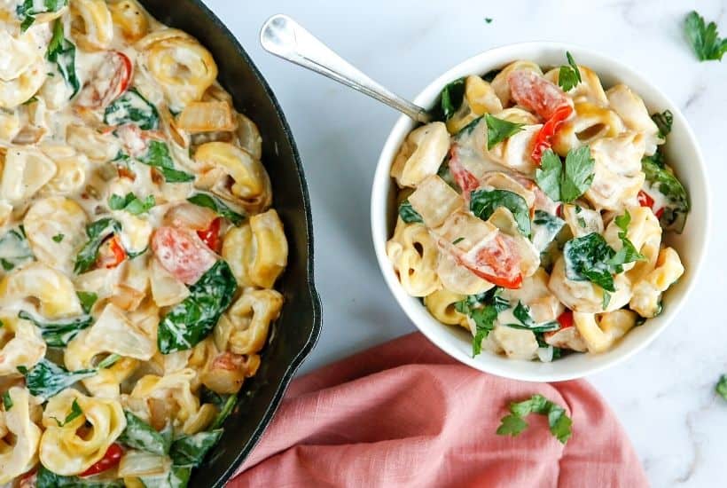 Enjoy the fresh taste of tortellini, shredded cheese, baby spinach, and tomatoes mixed to create this tasty and fulfilling Creamy Tortellini Pasta Skillet.