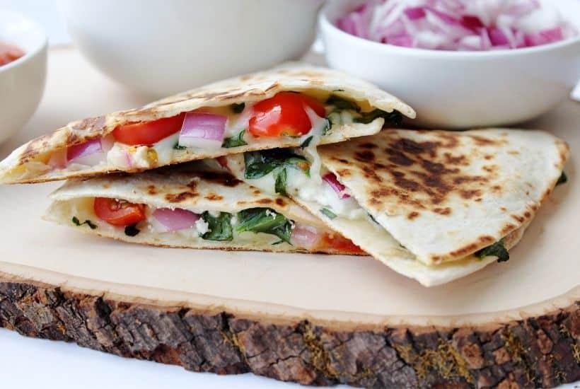 If you love the classic cheese quesadilla, then you will love this fun twist. Use this Mediterranean Quesadillas recipe to prepare a cheesy meat-free meal full of fresh vegetables. These quesadillas are perfect to eat for breakfast, lunch, or dinner! This easy quesadilla recipe is a delicious meatless meal idea. It's a perfect sandwich recipe for lunch or dinner.