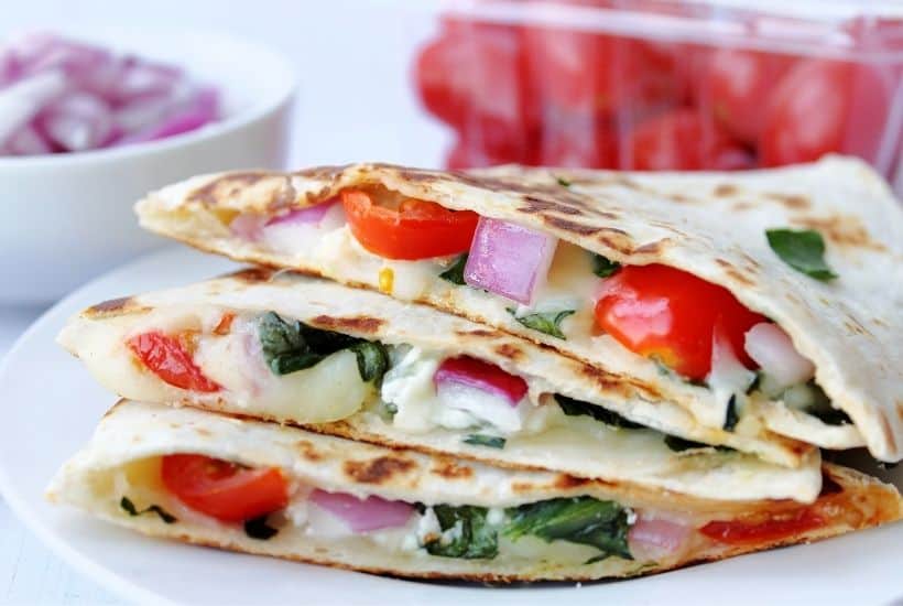 If you love the classic cheese quesadilla, then you will love this fun twist. Use this Mediterranean Quesadillas recipe to prepare a cheesy meat-free meal full of fresh vegetables. These quesadillas are perfect to eat for breakfast, lunch, or dinner! This easy quesadilla recipe is a delicious meatless meal idea. It's a perfect sandwich recipe for lunch or dinner.