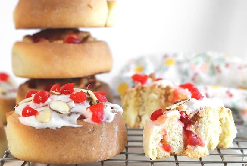 If you love eating baked goods for breakfast, try this Swedish Breakfast Rolls Recipe. These rolls are sweet, soft, fluffy, and perfect to eat for a quick grab and go breakfast. This easy Swedish breakfast bun recipe is consists of a sweet dough flavored with cardamon. Almonds and cherries are added and the sweet rolls are topped with a delicious icing glaze.