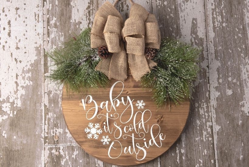 Make a decorative piece to hang in your home with this easy winter craft idea. Make a DIY Farmhouse Winter Door Hanging Sign that will add a special touch to any room in the home. This Christmas Cricut craft is a great project to make. It can be left up long after Christmas is over. Be sure to download the FREE SVG file