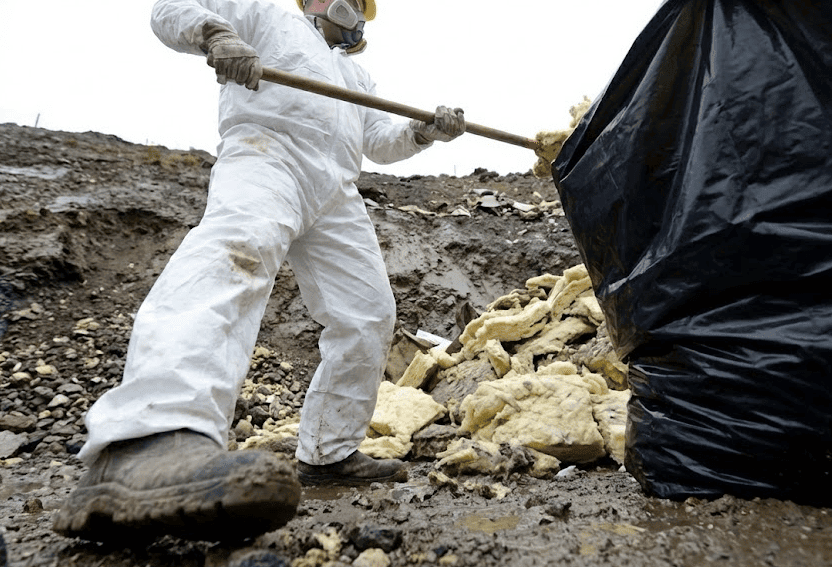 Professional team carrying out Asbestos Removal Grantham by bagging loose-fill insulation debris. Asbestos. Asbestos Disposal Grantham