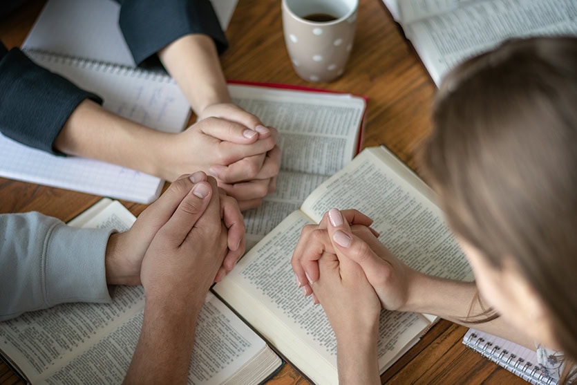 Christian worship and praise. Happy friends praying and reading