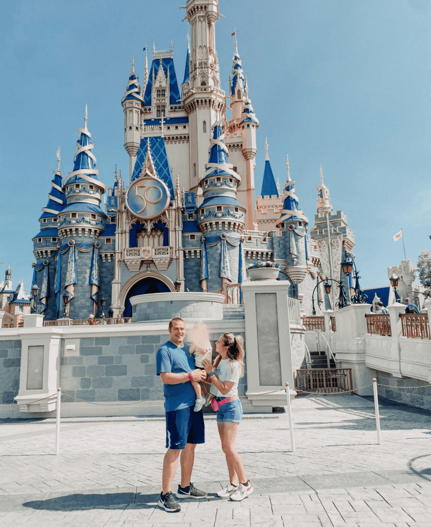 Family enjoying day at Disney Castle in Magic Kingdom theme park.