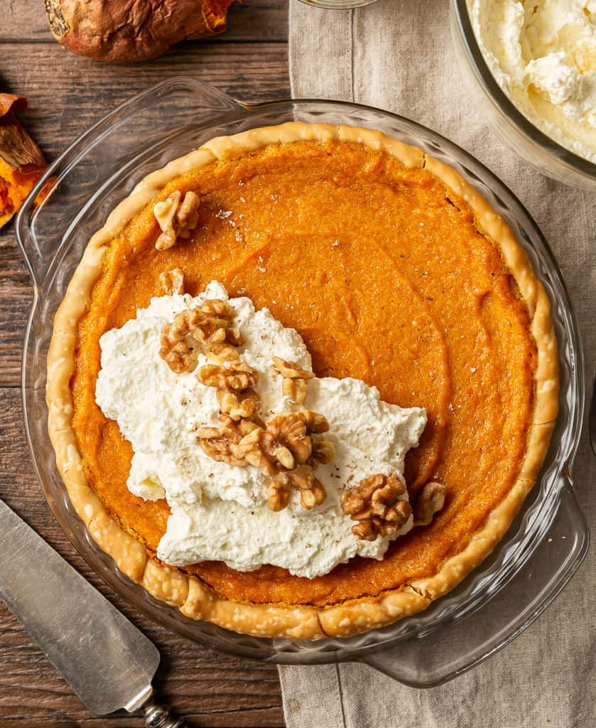 sweet potato pie with bourbon whipped cream and walnuts