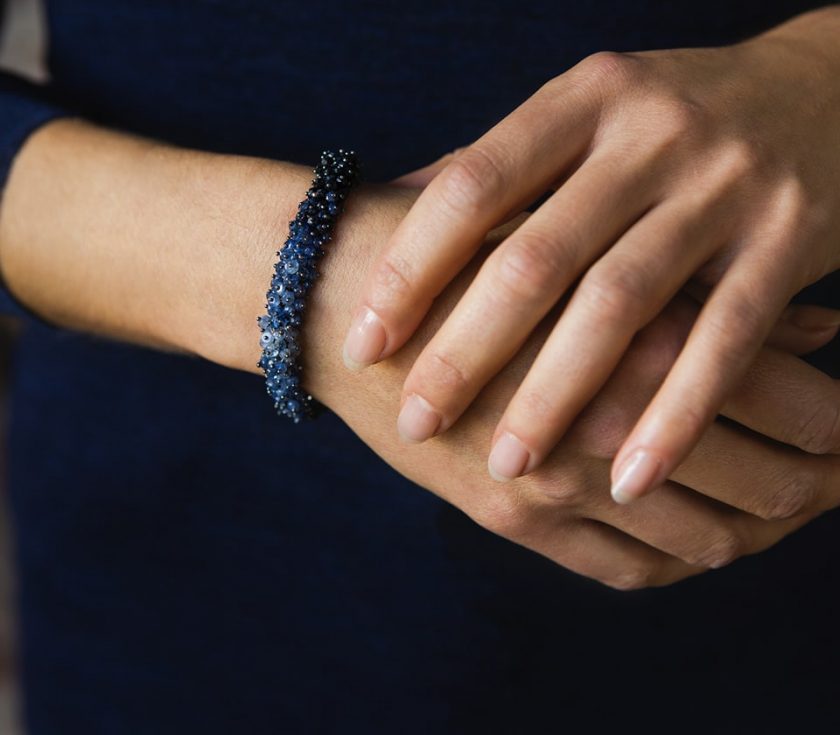 Model's hands wearing a sapphire bracelet