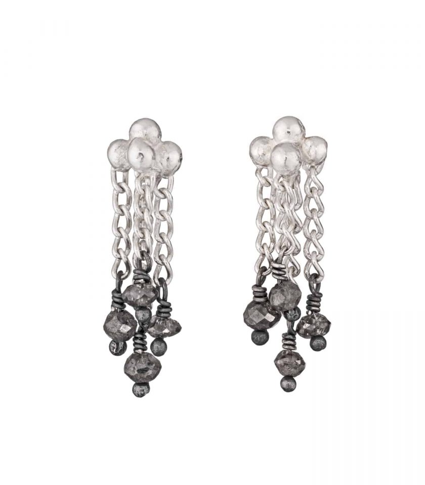 Photo of diamond and silver chain earrings on white background