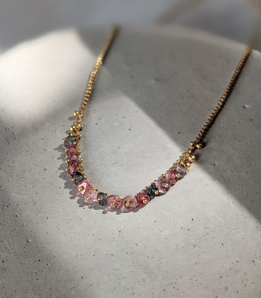 Pastel spinel and gold vermeil necklace on a grey background