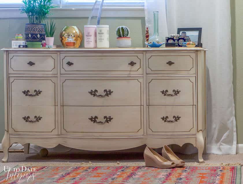 French provincial dresser in bedroom with eclectic rug and shoes. Before how to paint a dresser without sanding.