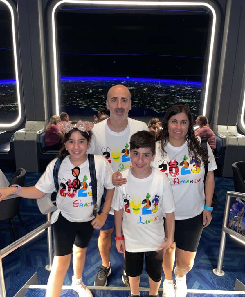 Enjoying a space-themed simulation at Orlando's 407 Vacation Co. during a family vacation.