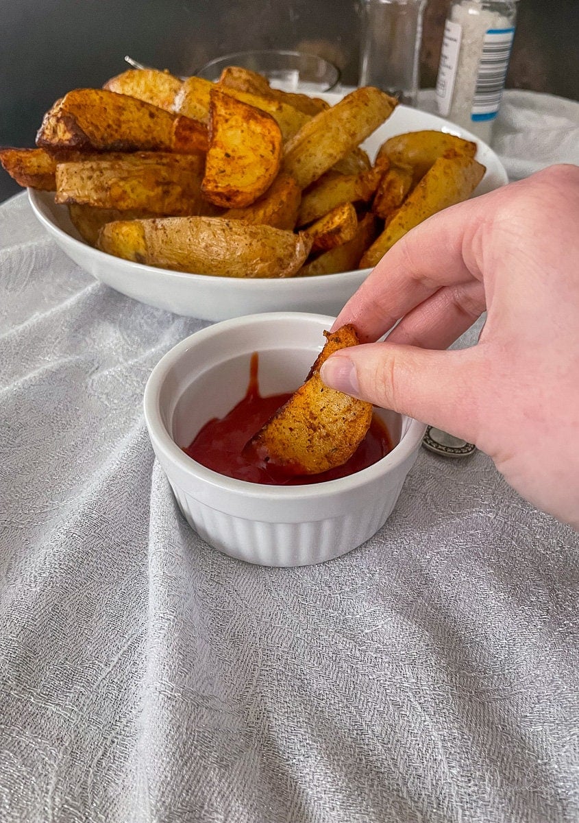 wedge being dipped in ketchup.