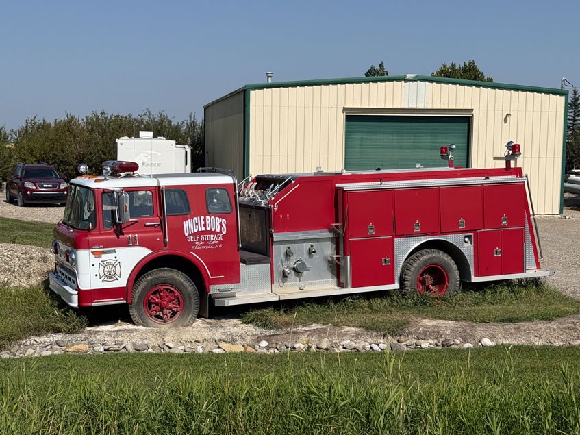 Red Uncle Bob's truck parked in front of an Okotoks storage facility.
