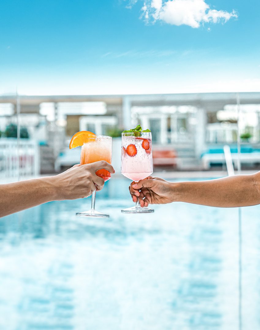 5 Refreshing cocktails by the pool at Media One Hotel, perfect for sunny days and relaxed gatherings under the blue sky.