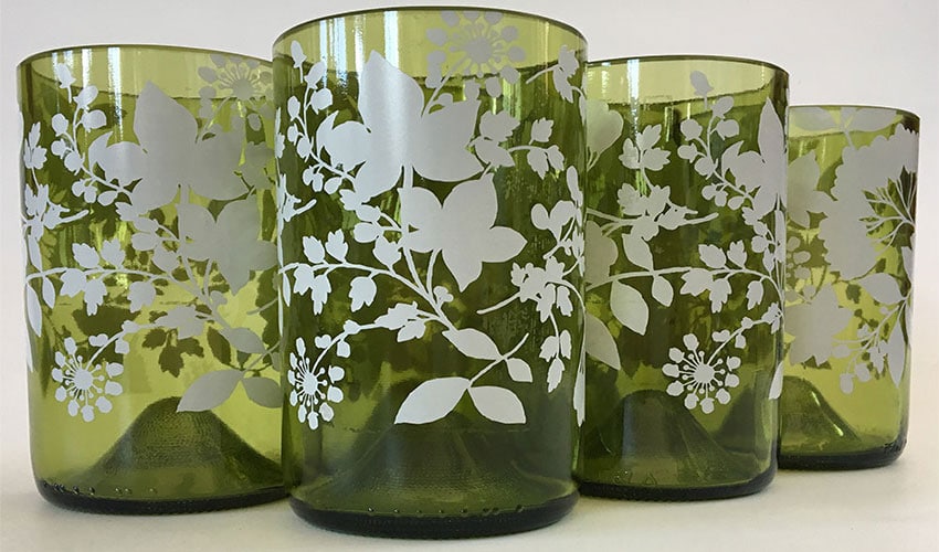 Picture of glasses that have been made by cutting glass bottles in half