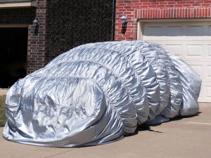 Inflatable cover protecting car roof from dents caused by hail and debris.