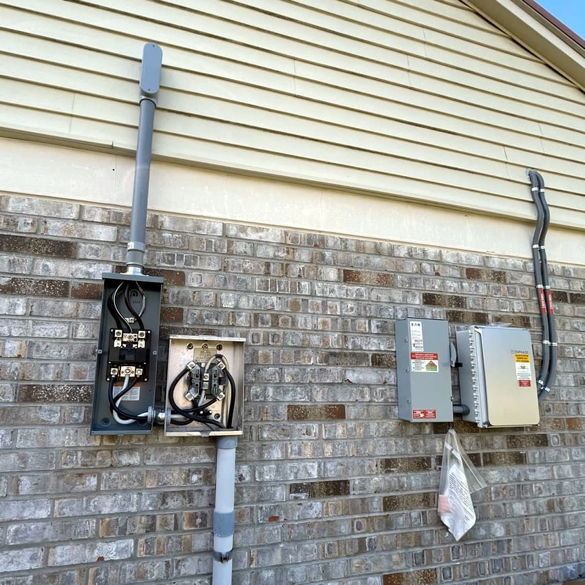 A newly installed outdoor electrical service box system. Part of it opened so you can see how the cords are organized inside.