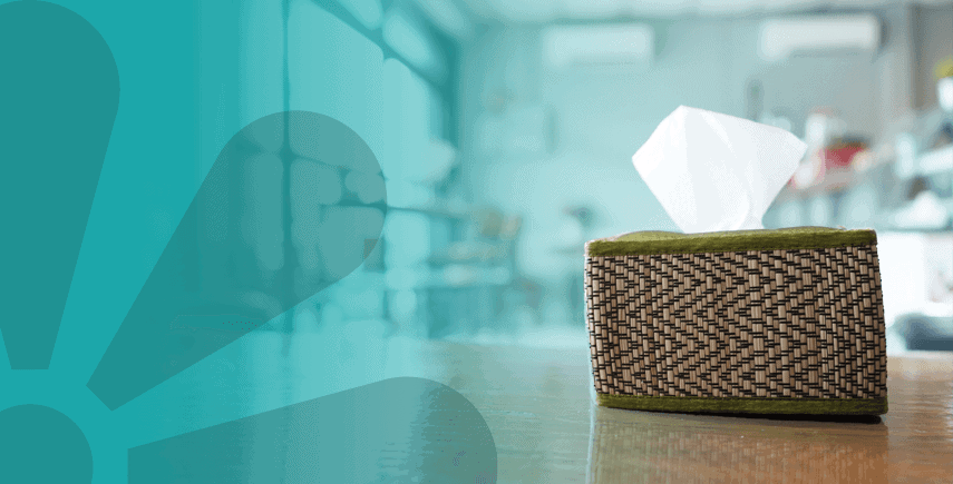 Woven tissue box with a tissue pulled out on a table, promoting proper tissue usage for hygiene.