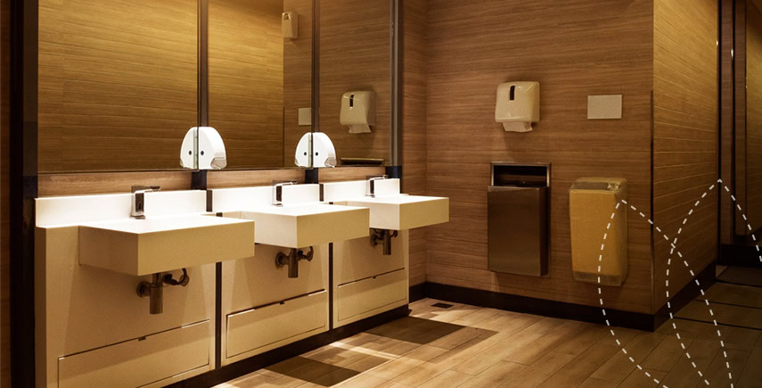 Modern washroom with clean sinks, mirrors, and paper towel dispensers, ensuring washroom hygiene standards.
