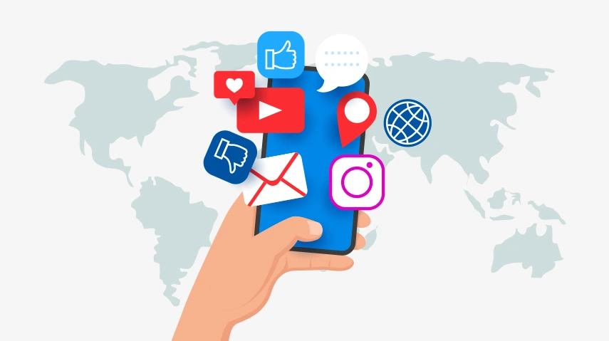 Hand holding smartphone with social media app icons over world map