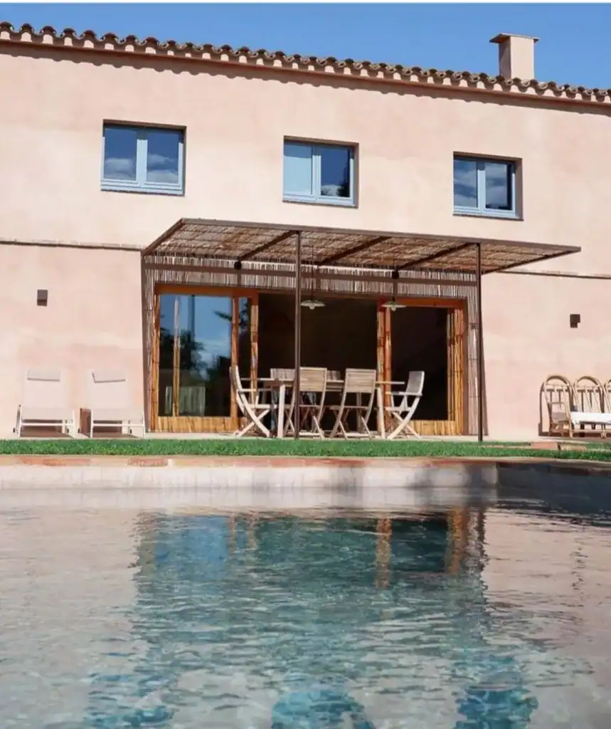 Modern Mediterranean-style house with a private pool and outdoor dining area, perfect for relaxing and entertaining in a stylish vacation home.