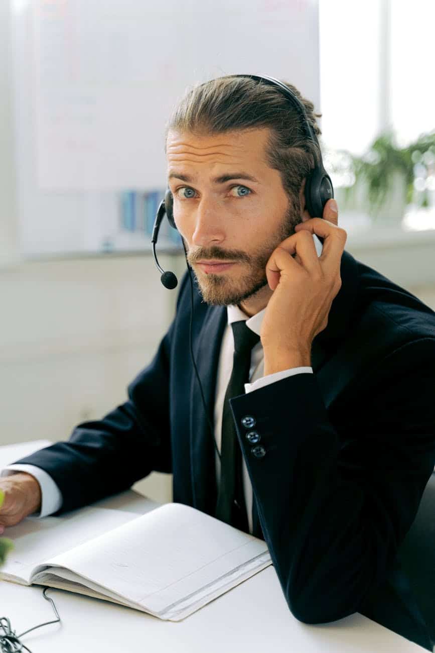 man in black suit jacket wearing a headset
