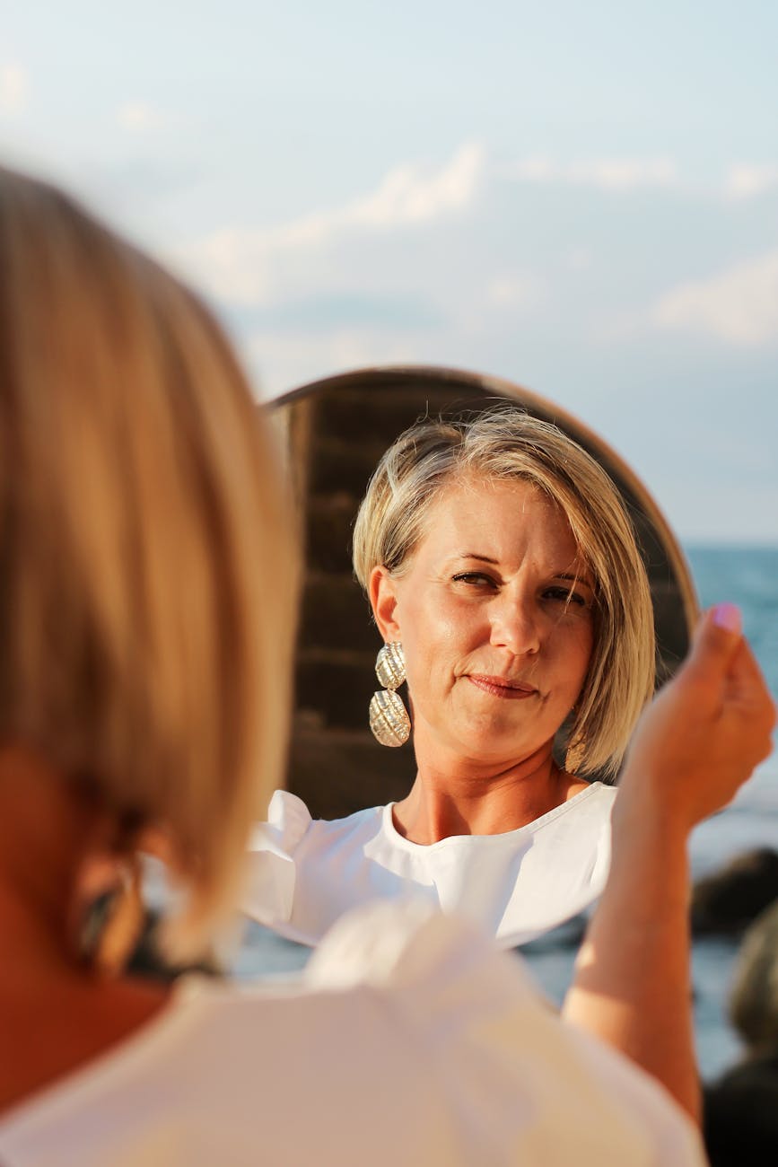 middle aged woman looking in a mirror