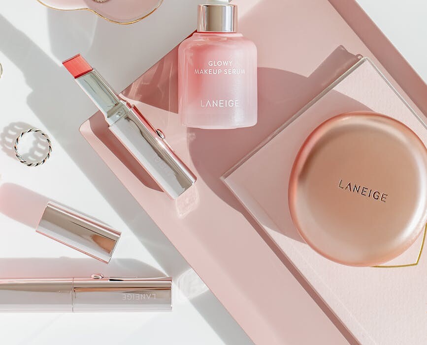 skincare and makeup products in elegant flat lay