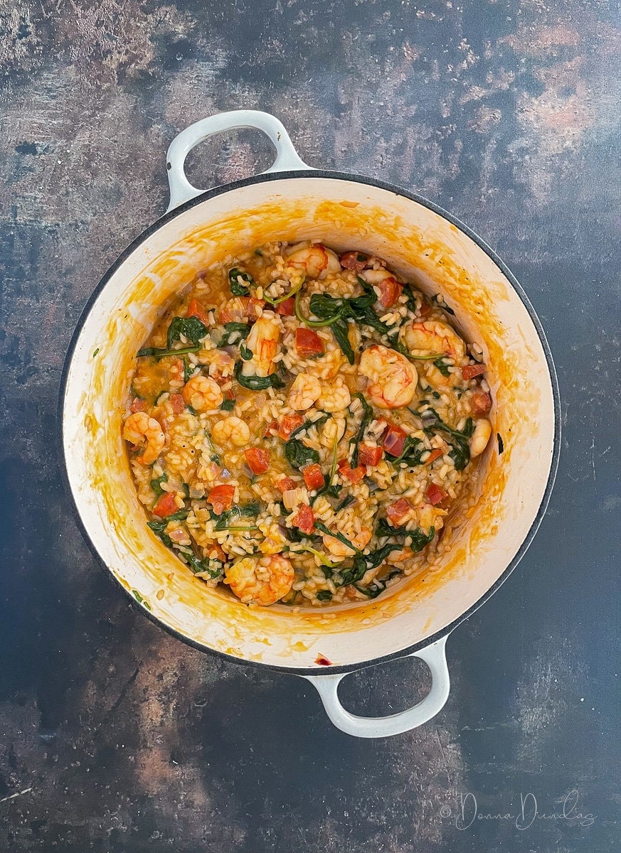 prawn and chorizo risotto cooking in cast iron dish.